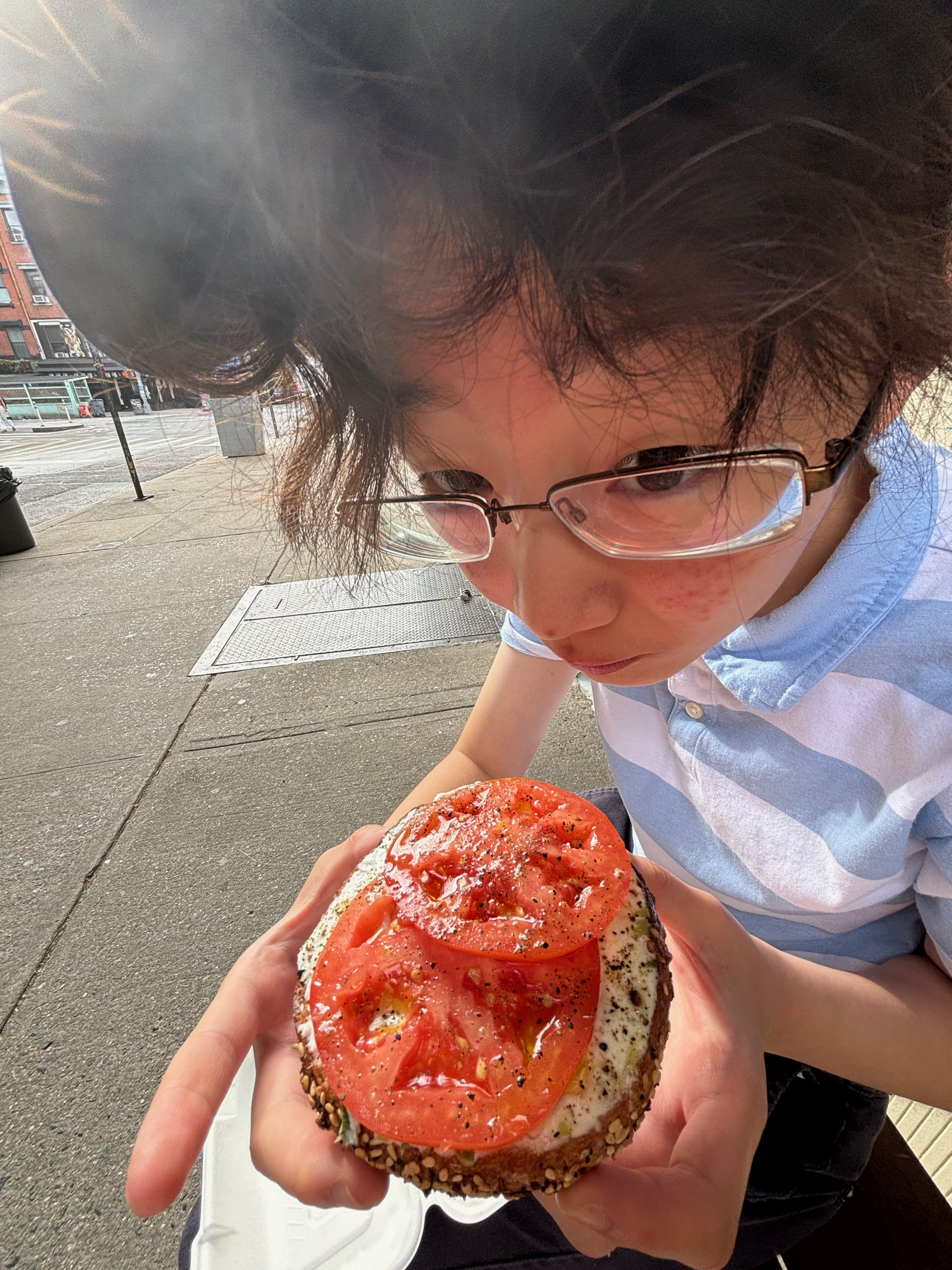 Munching on a tomato bagel from Apollo Bagels